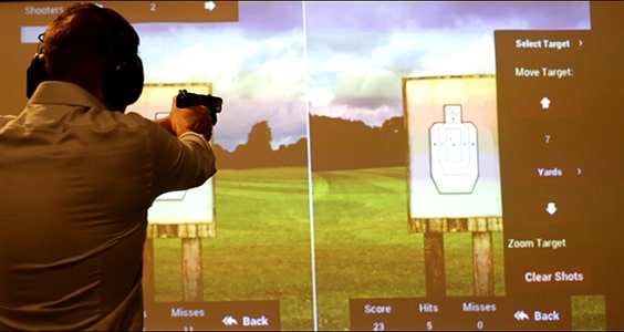 Demonstration of pistol training with recoil simulation technology.