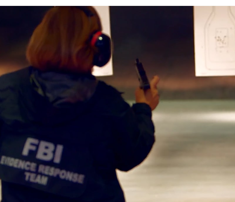 A FBI agent reloading her pistol.