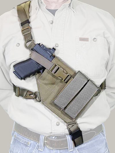 A demonstration a chest holster with 4 straps, with one hooking on the belt.