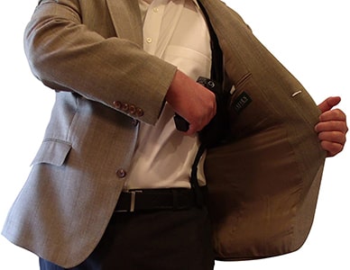 Pistol shoulder holster demonstrates how it's concealed under a jacket.