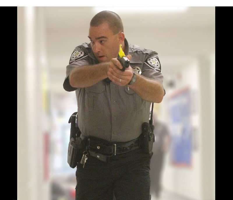 An officer about to shoot in a training exercise.